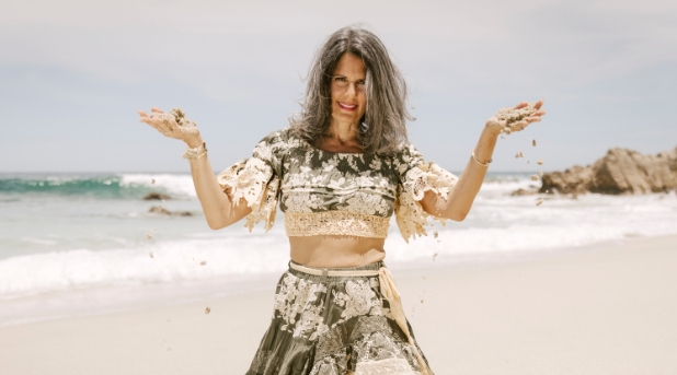 Amanda Hansonon on beach holding rocks